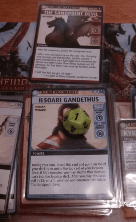 Pathfinder Adventure Card Game: Rise of the Runelords – Base Set - Well it had to happen sometime right? Played Ilsoari Gandethus and rolled a 1 on a d12 which summoned The Sandpoint Devil who then kicked my teeth in >.< - Credit: 1havok12