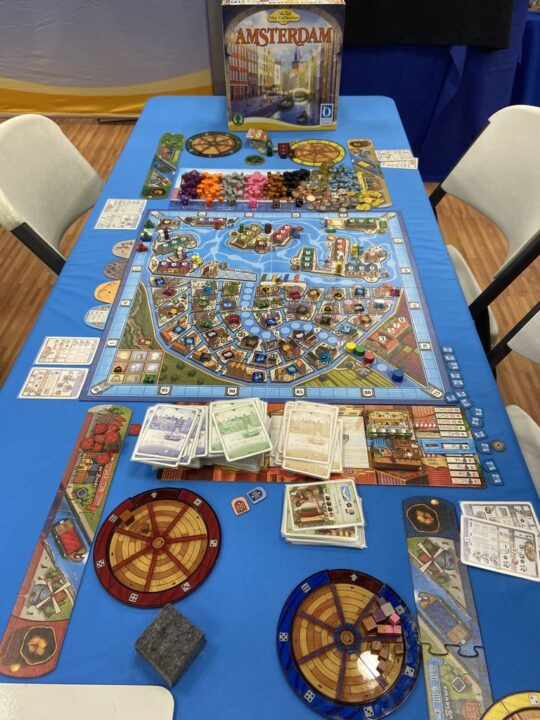 Amsterdam - Amsterdam, Queen Games, 2022 — production copy being played at Gen Con 2022 - Credit: W Eric Martin