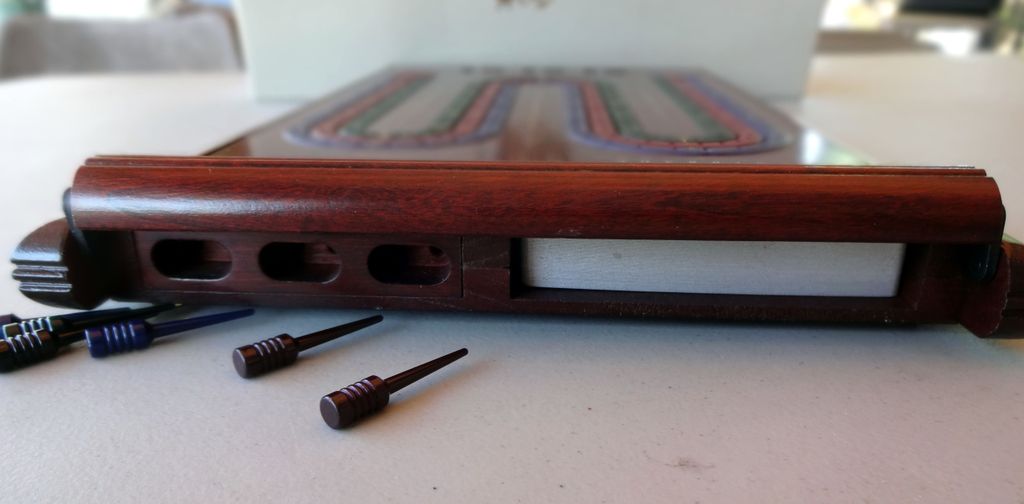 Cribbage - Noble Games cribbage board concealed compartment holds pegs and playing cards. - Credit: CurtisC
