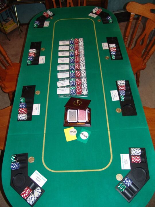 Poker - This is our regular League night setup. Chips set up for Table 1 and chip trays ready for players to take to table two. Includes: Chip trays, cut cards for the decks, and card markers from Hardrock Casino in Vegas. The Seat cards label the table and seat - Credit: Bixby